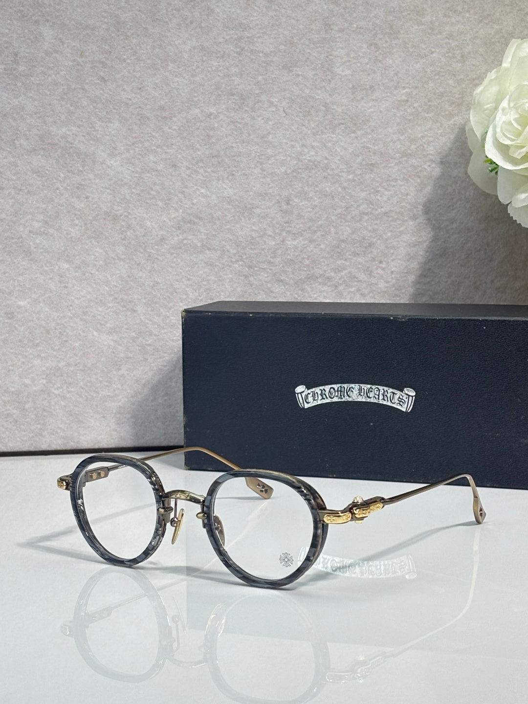 Chrome-finish round eyeglasses with dark frames and clear lenses