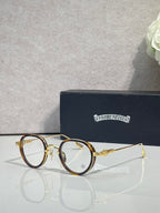 Chrome-finish round eyeglasses with gold frames and clear lenses