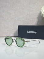 Chrome round glasses with green lenses and green frame, metal hinge details