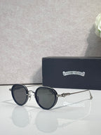Chrome round glasses with dark tinted lenses and dark frames, slim metal arms