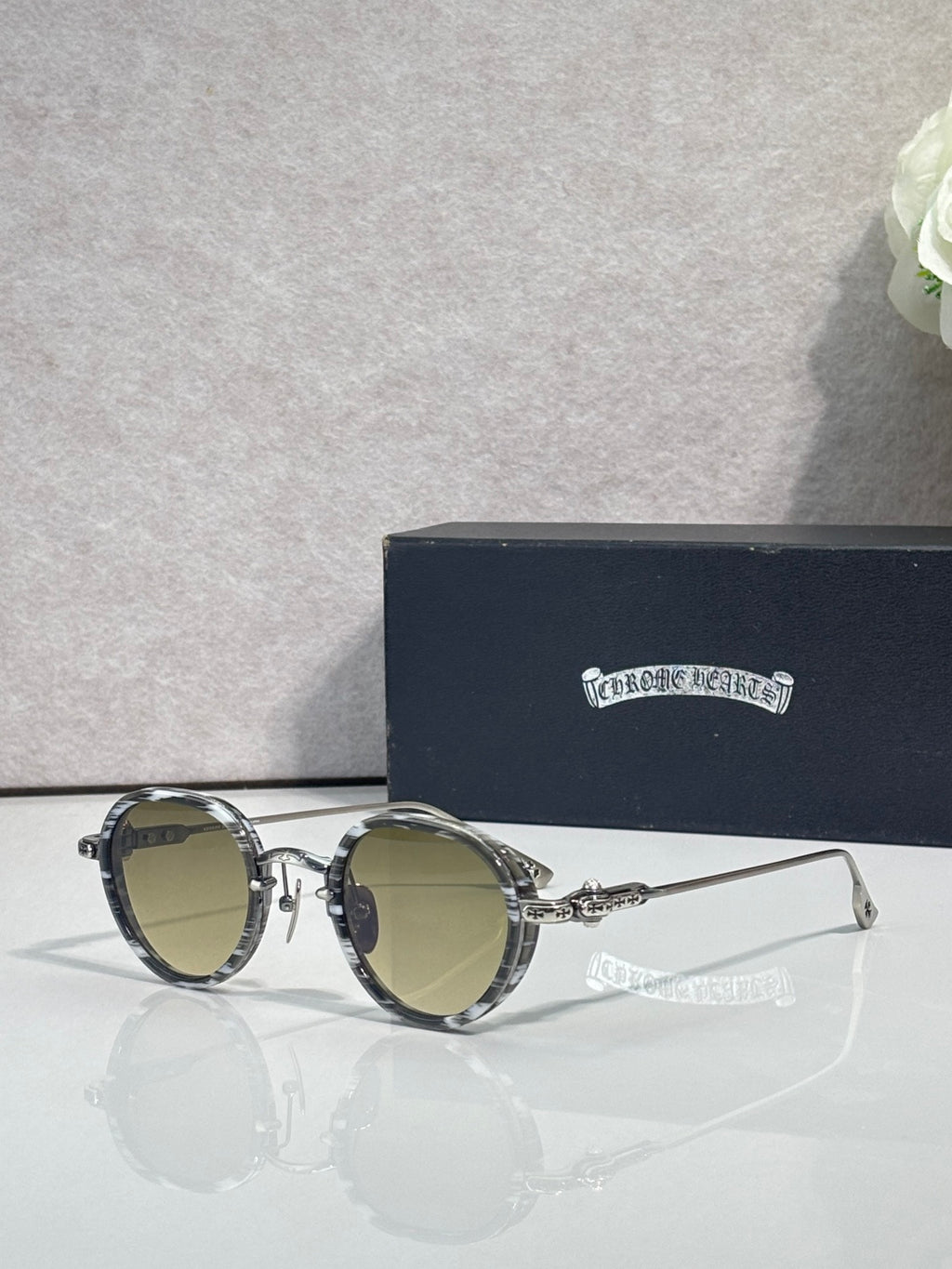 Chrome round glasses with olive lenses and silver frame, gold hinge details