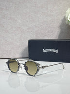 Chrome round glasses with olive lenses and silver frame, gold hinge details