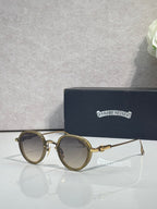Chrome round glasses with light brown lenses and gold metal frame