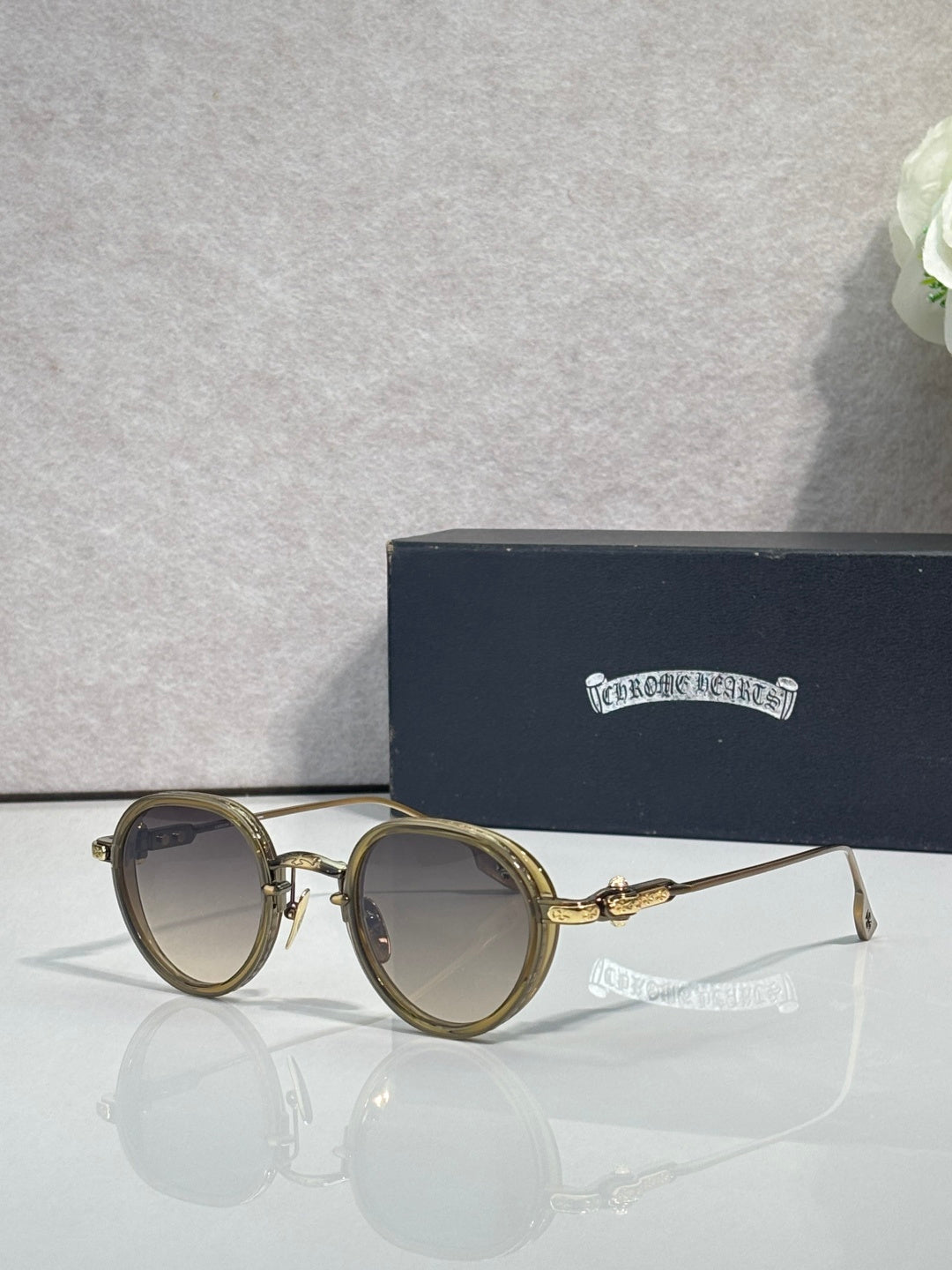 Chrome round glasses with light brown lenses and gold metal frame