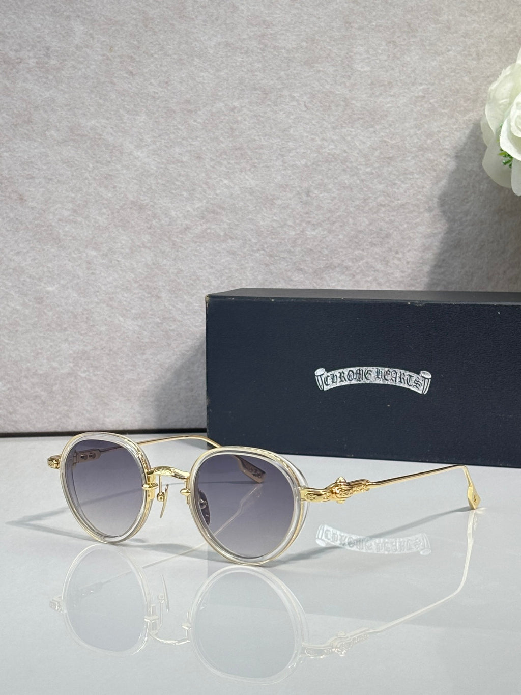 Chrome round glasses with light tinted lenses and gold frame