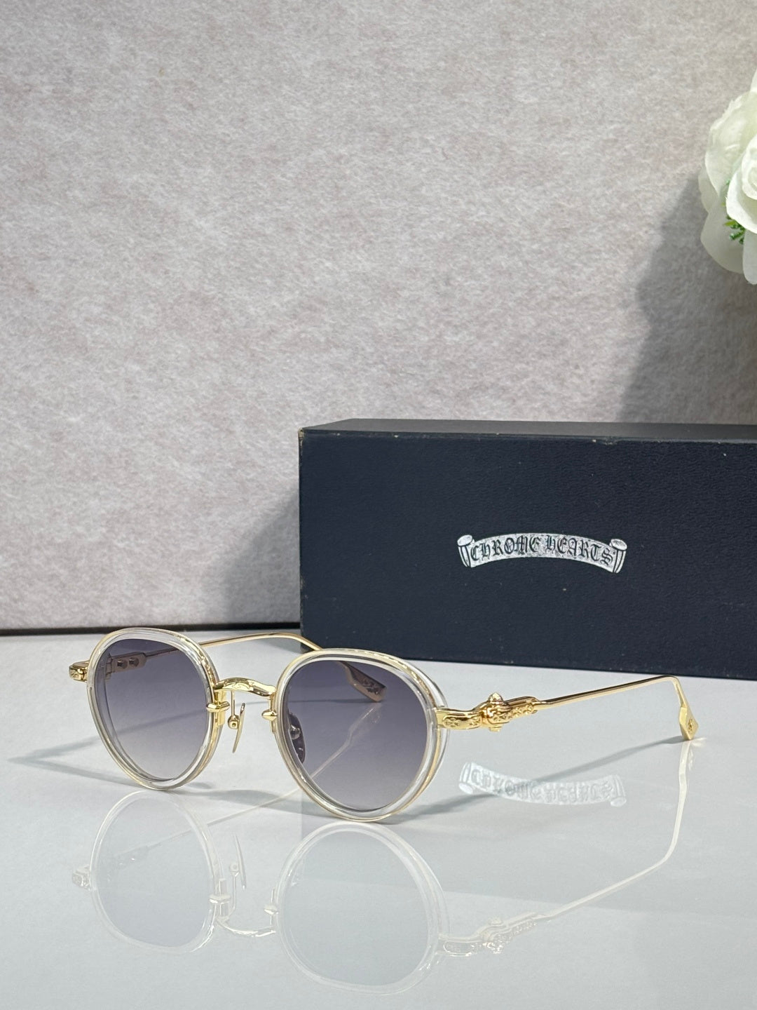 Chrome round glasses with light tinted lenses and gold frame