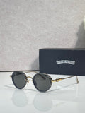 Chrome round glasses with dark lenses and black frames, gold accents