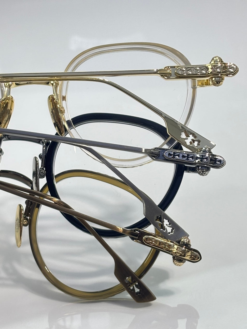 Chrome-finish round eyeglasses close-up of engraved temple and hinge detail