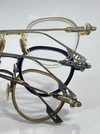 Chrome-finish round eyeglasses close-up of engraved temple and hinge detail