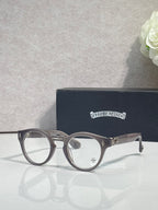 Gray round eyeglasses with gold-tone detailing and clear lenses
