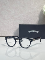 Black round eyeglasses with gold-tone detailing and clear lenses