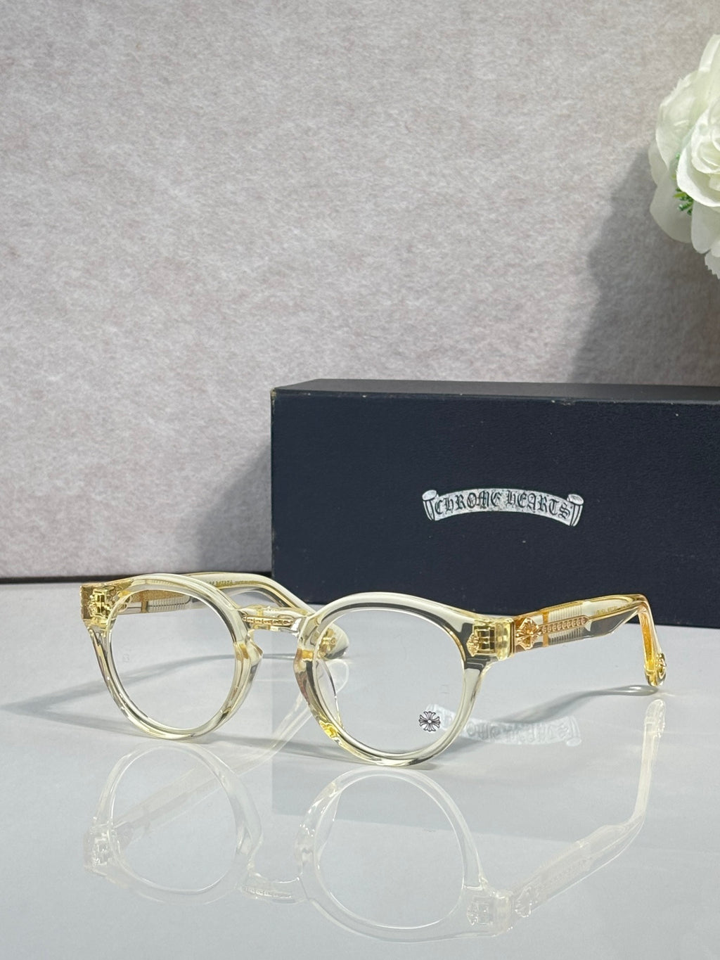 Gold round eyeglasses with clear lenses and gold-tone bridge details