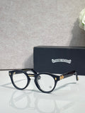 Dark blue round eyeglasses with gold-tone detailing and clear lenses