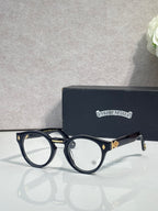 Dark blue round eyeglasses with gold-tone detailing and clear lenses