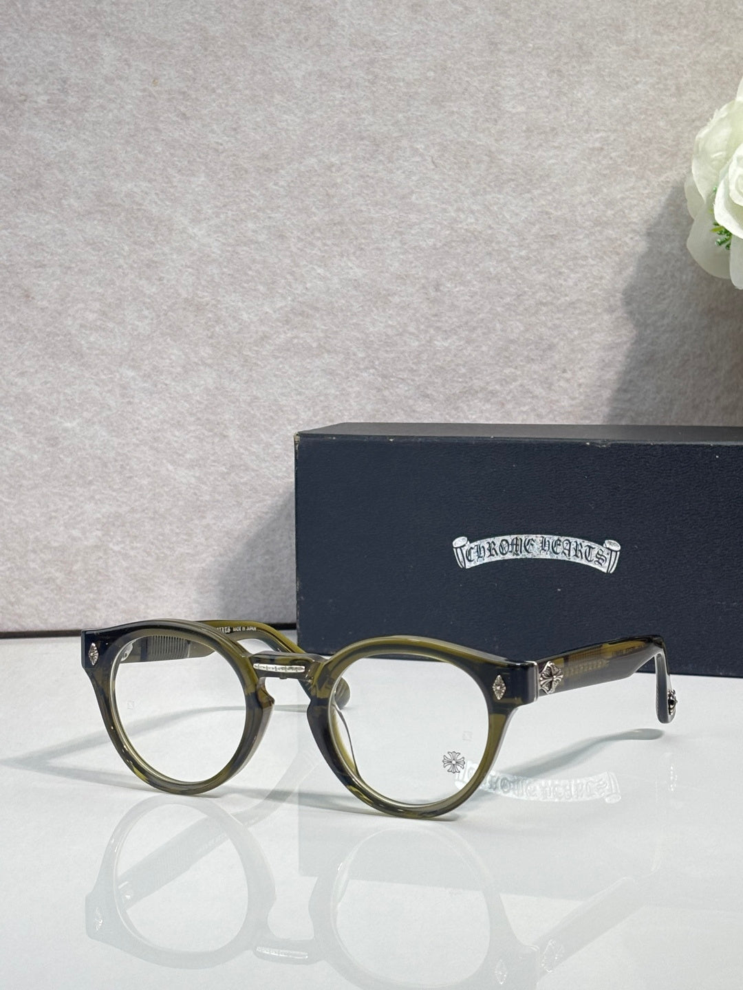Olive round eyeglasses with gold-tone detailing and clear lenses