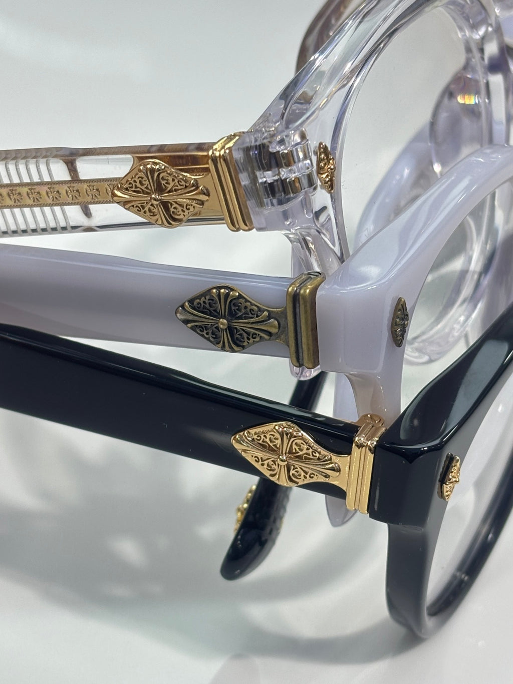 Clear round eyeglasses with gold temple hardware and blue-tinted frame