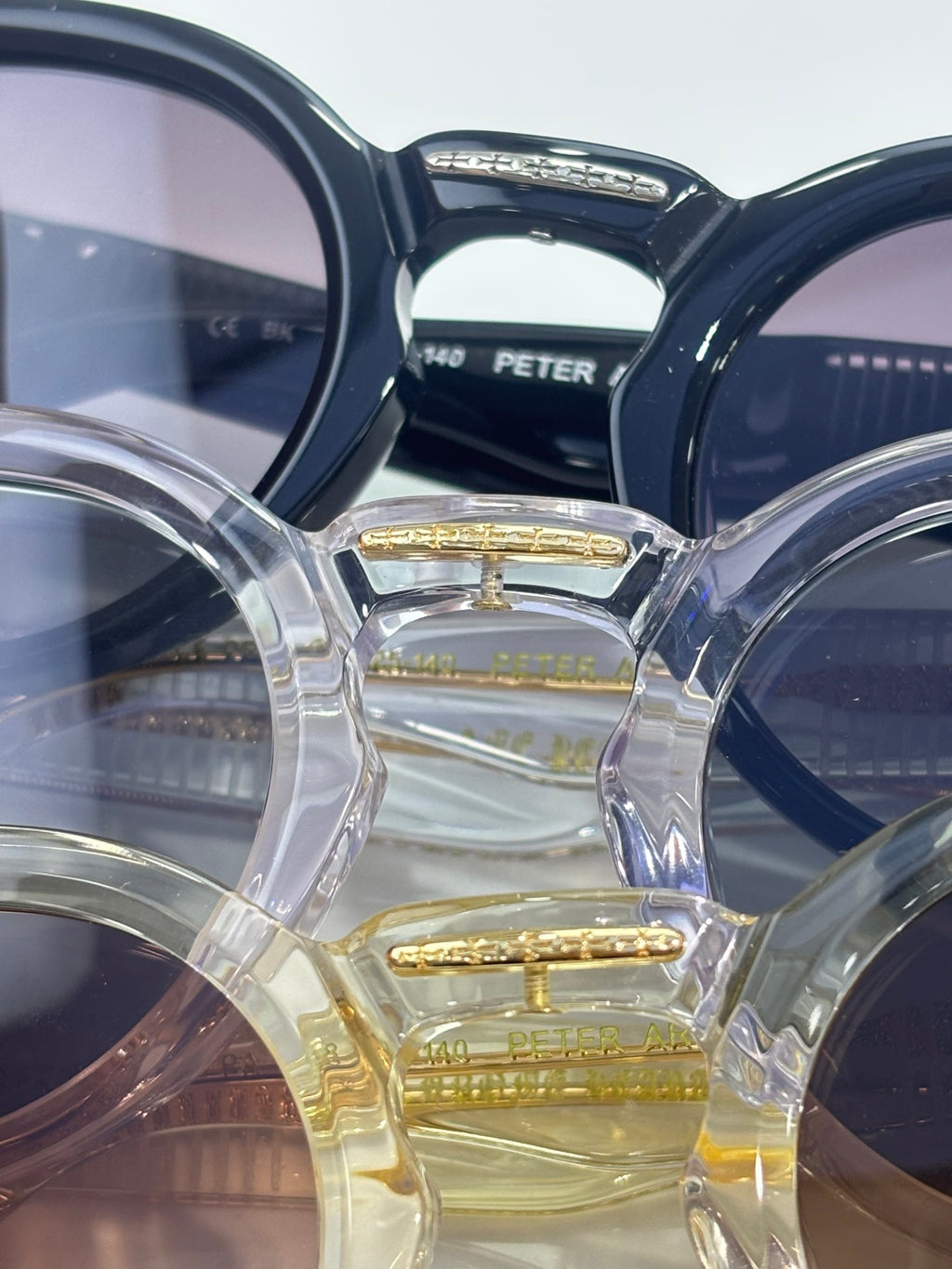Close-up of multiple chrome-framed sunglasses with tinted lenses