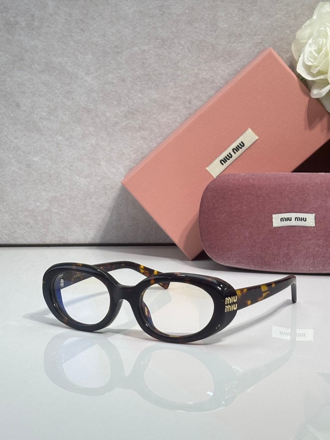 MiuMiu sunglasses with dark frame and light lenses