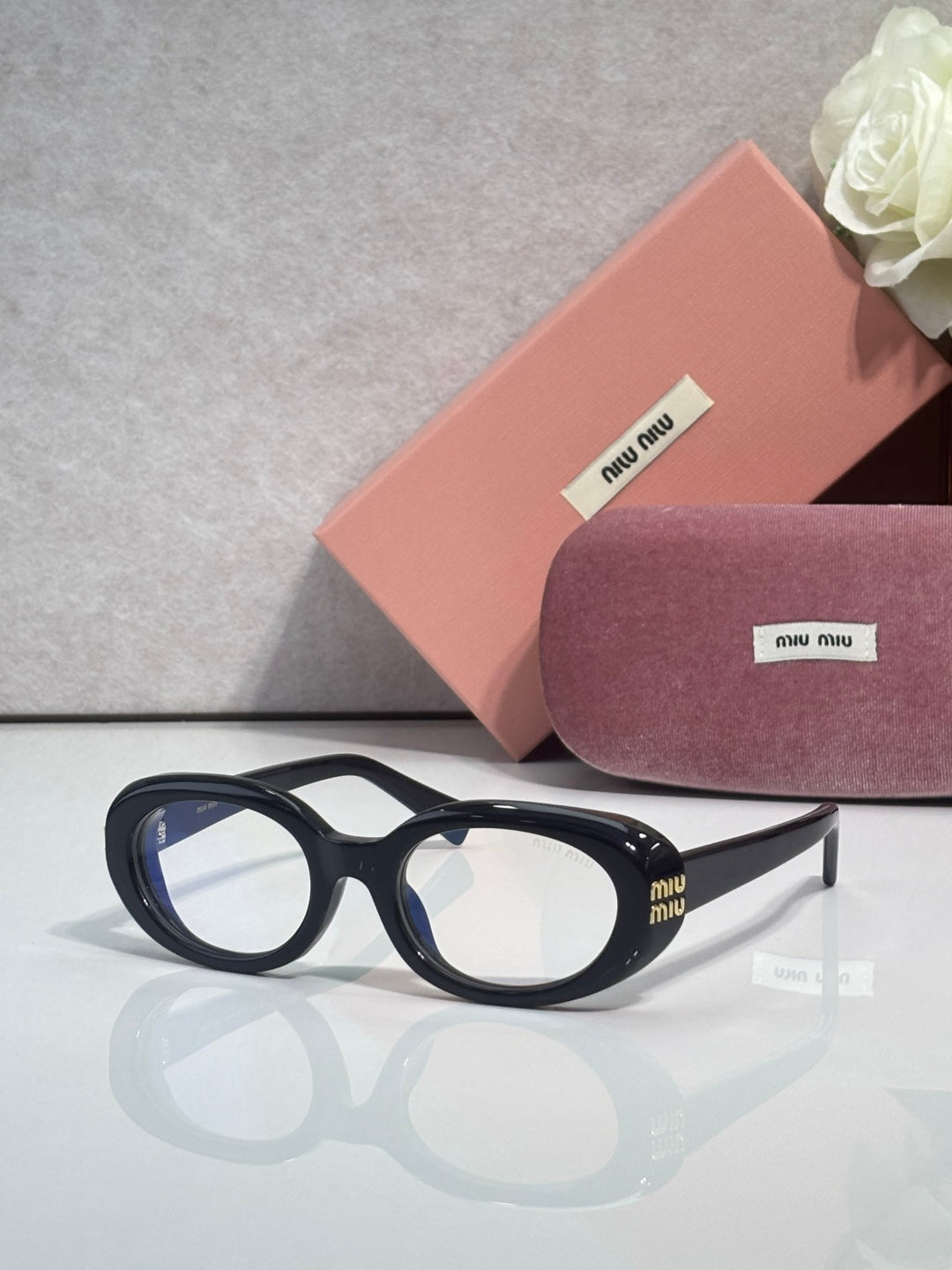 MiuMiu sunglasses with black frame and clear light-blue lenses