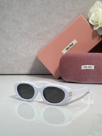 MiuMiu sunglasses with white frame and dark round lenses