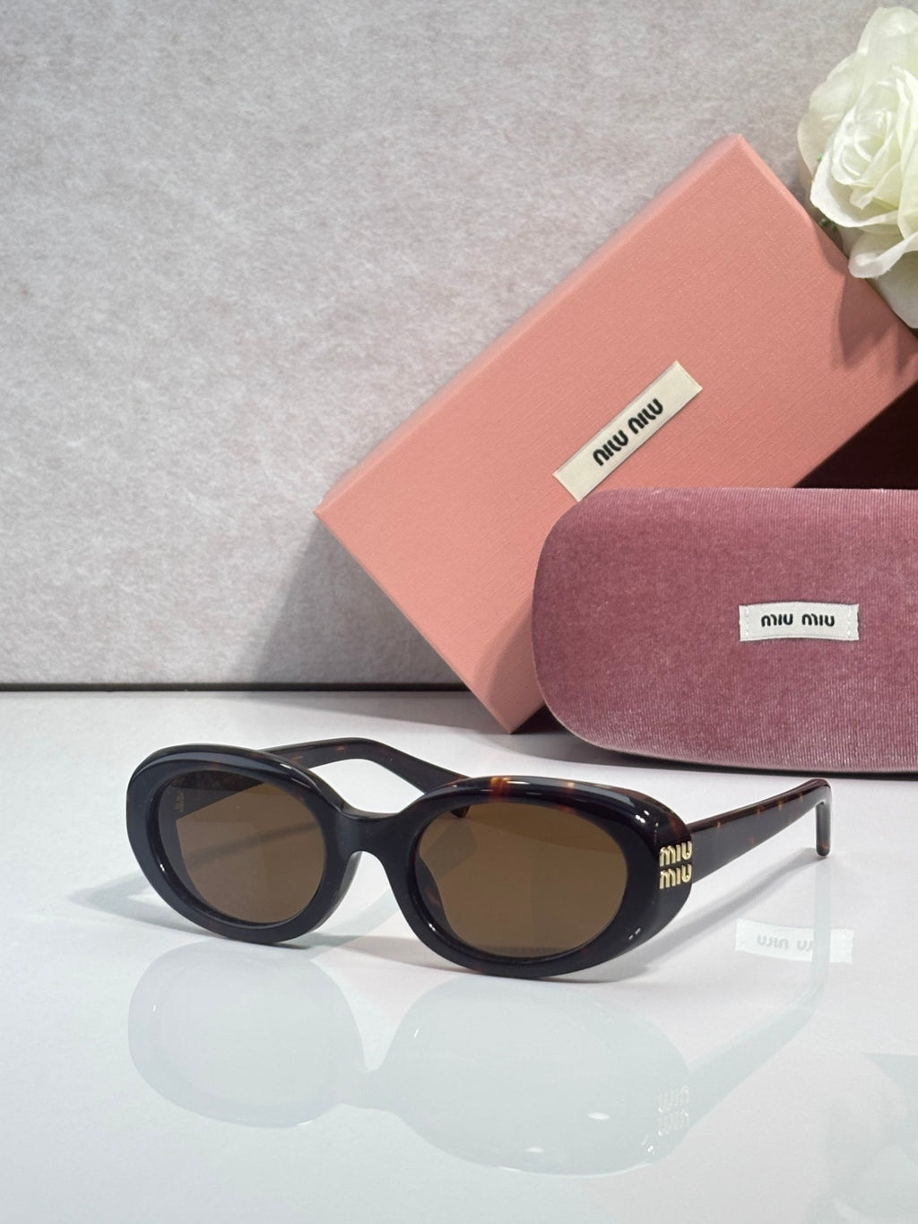 MiuMiu sunglasses with black frame and brown tinted lenses
