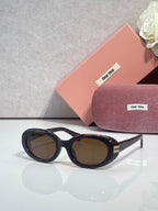 MiuMiu sunglasses with black frame and brown tinted lenses