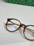 Gucci eyeglasses close-up with clear lenses and brown plastic frame temples