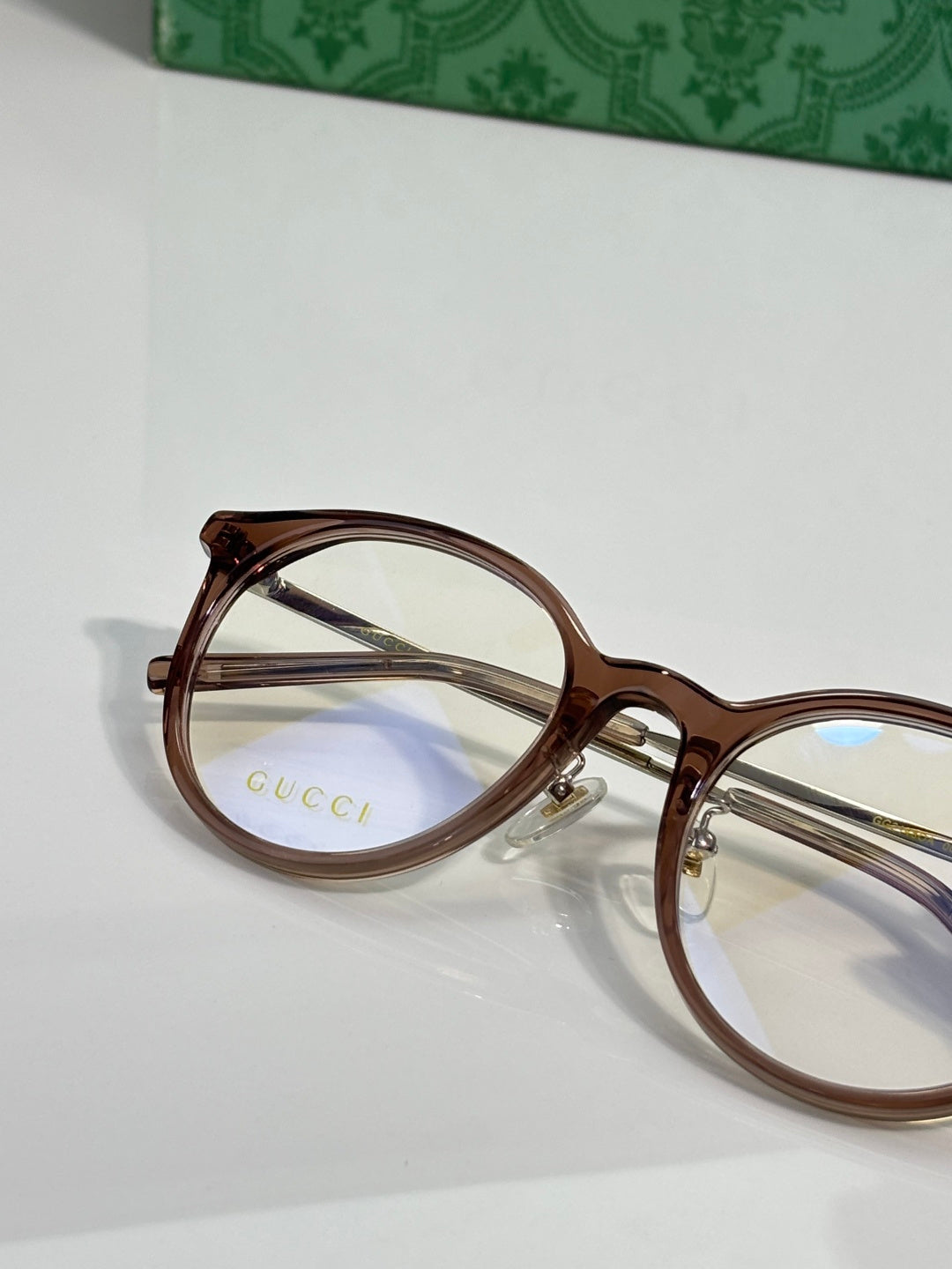 Gucci eyeglasses close-up with clear lenses and brown plastic frame temples