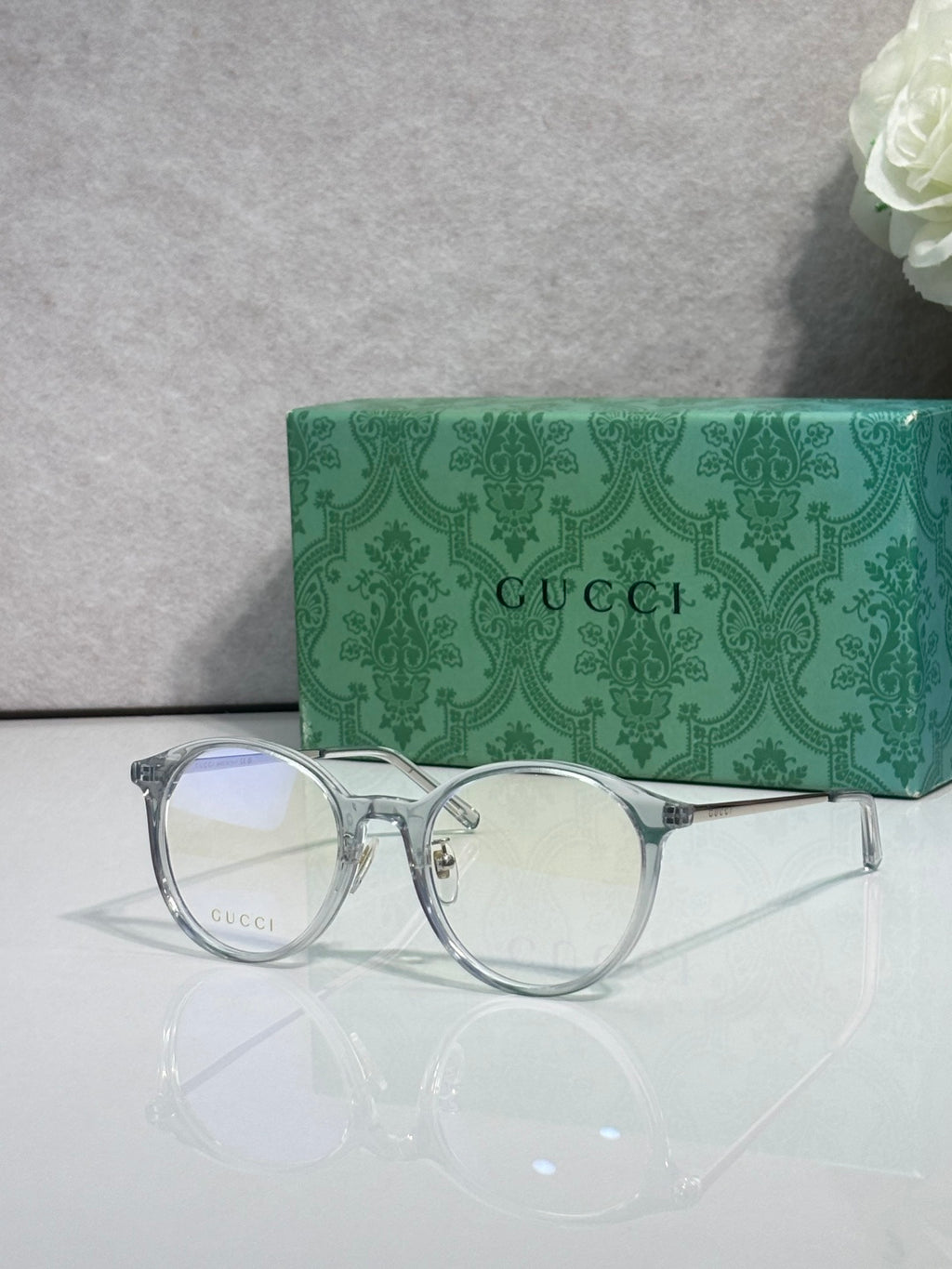 Gucci eyeglasses with clear lenses and silver metal frame, round corners