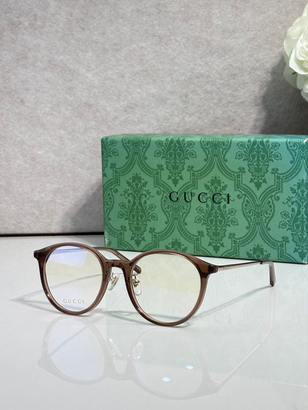 Gucci eyeglasses with clear lenses and dark brown plastic frame