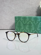 Gucci eyeglasses with clear lenses and tortoiseshell-style plastic frame