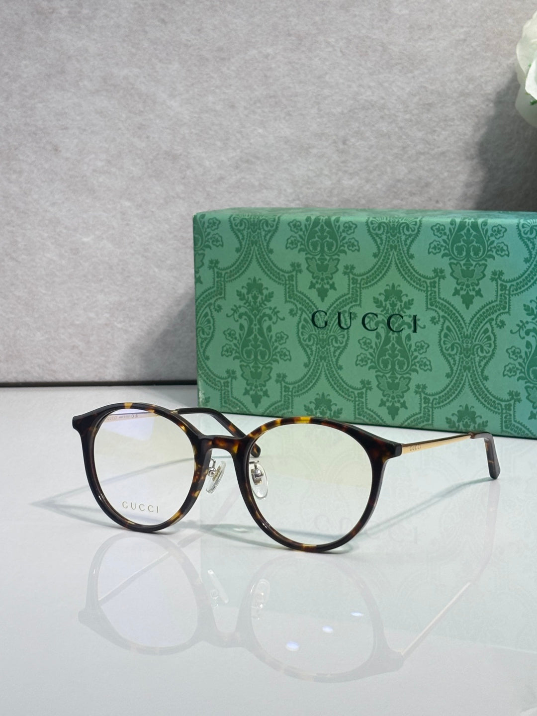 Gucci eyeglasses with clear lenses and tortoiseshell-style plastic frame