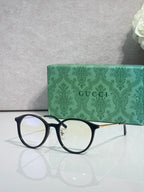Gucci eyeglasses with clear lenses and black plastic frame