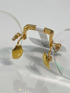 Gold metal eyeglass frame with curved temple and hinge details, clear lens