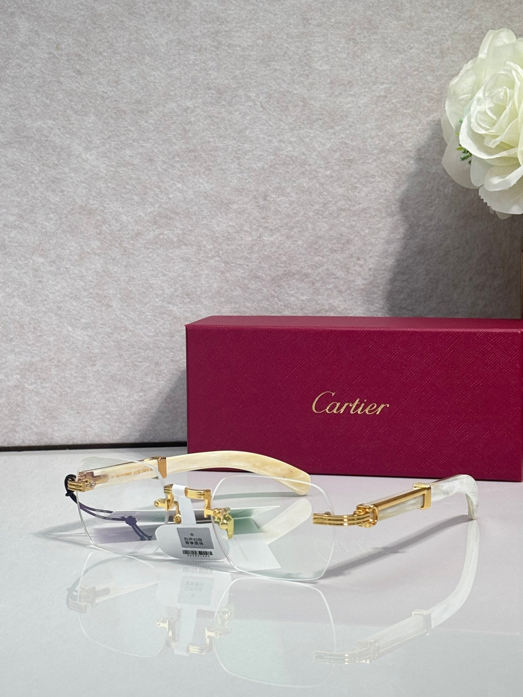Eyeglasses with clear lenses and gold metal frame, white temple arms
