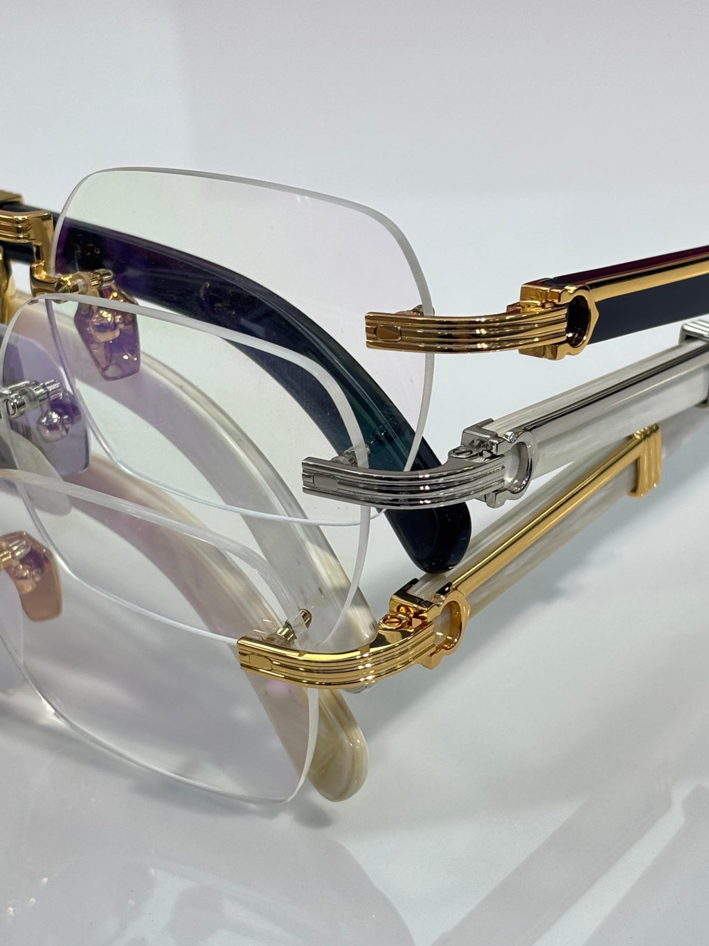 Eyeglasses side view with gold temple details, clear lenses, dark inner accent