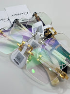 Assorted eyeglasses with clear lenses and gold-and-silver frames, tags attached