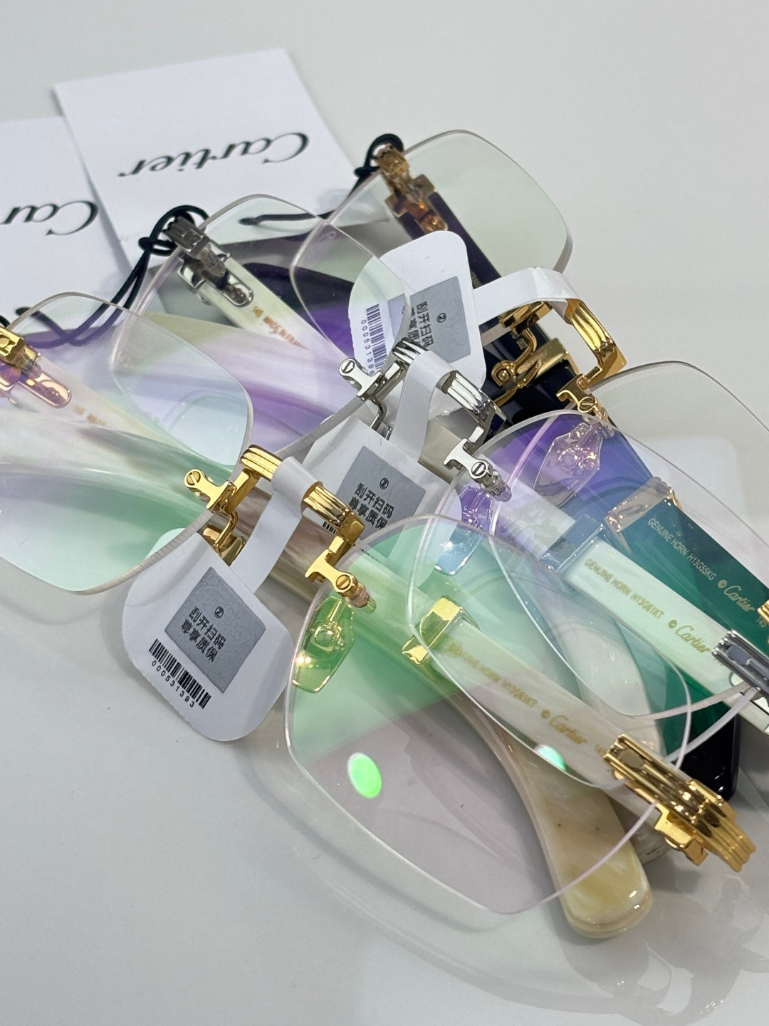 Assorted eyeglasses with clear lenses and gold-and-silver frames, tags attached
