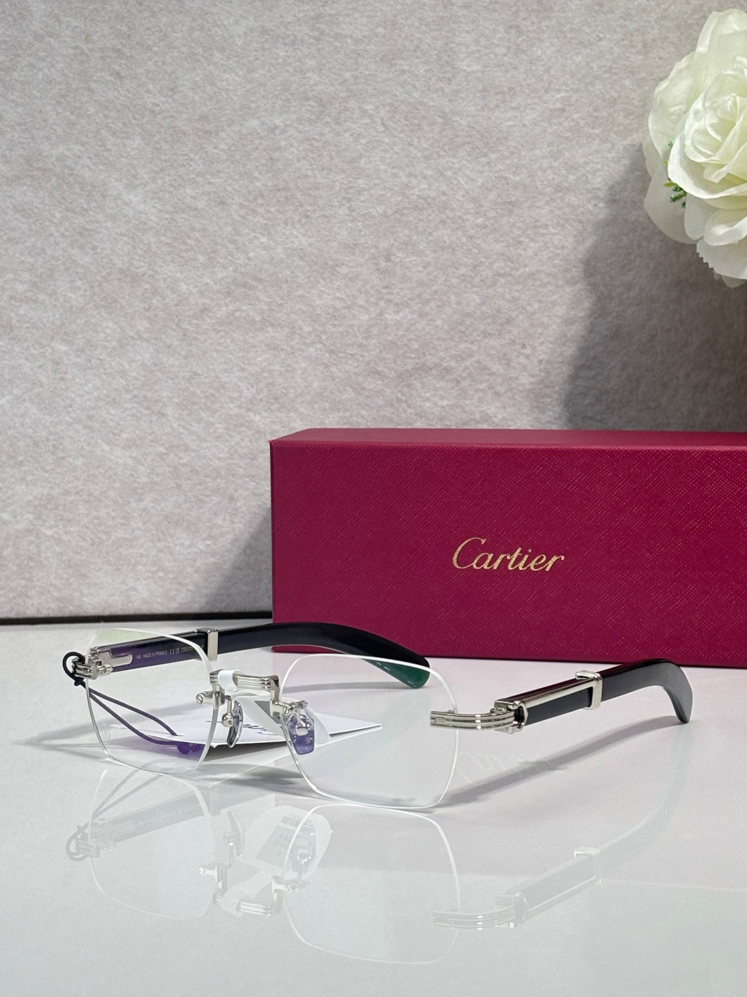 Eyeglasses with clear lenses and silver metal frame, dark top bar accent