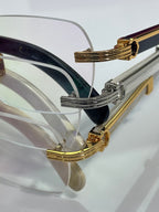 Eyeglasses side view with gold and silver frame accents and clear lens