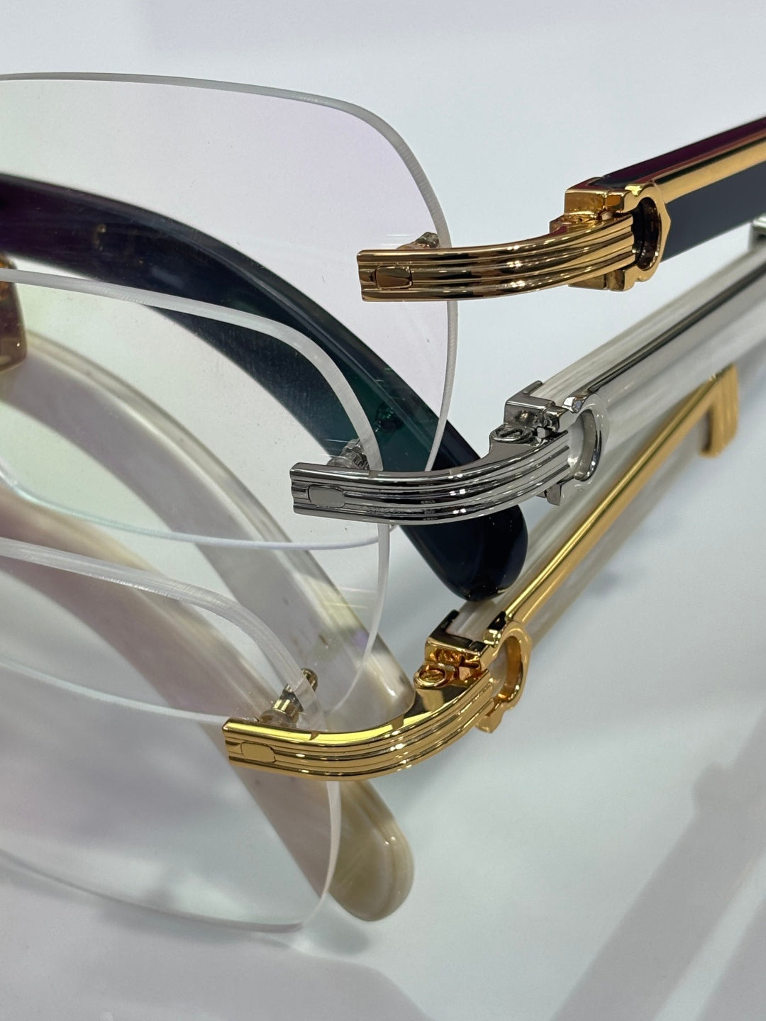 Eyeglasses side view with gold and silver frame accents and clear lens