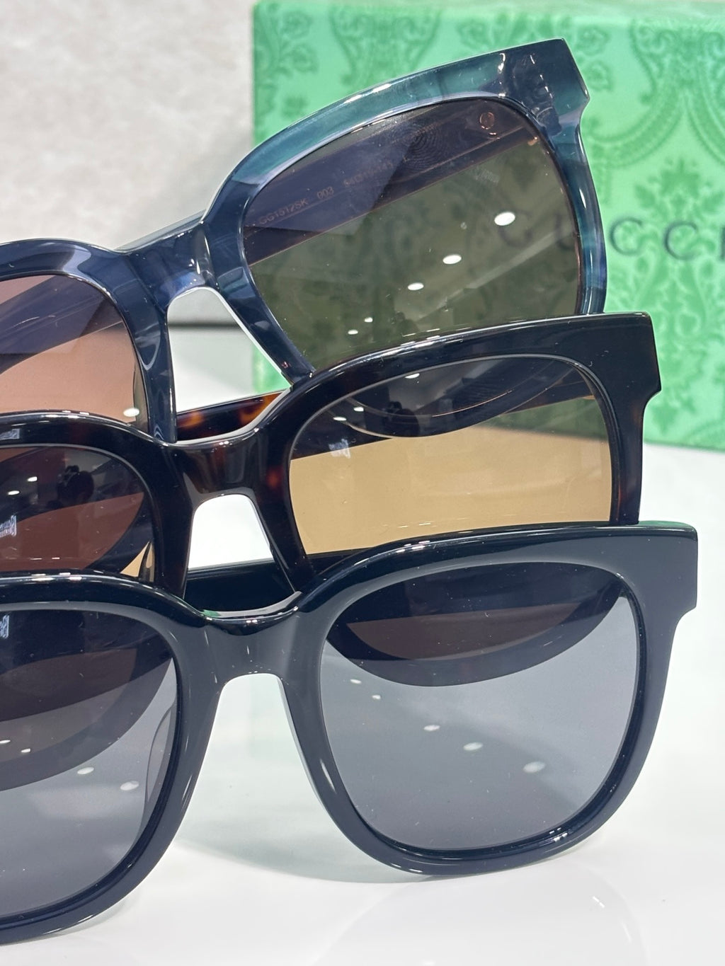 Gucci sunglasses with blue-tinted lenses and dark acetate frames