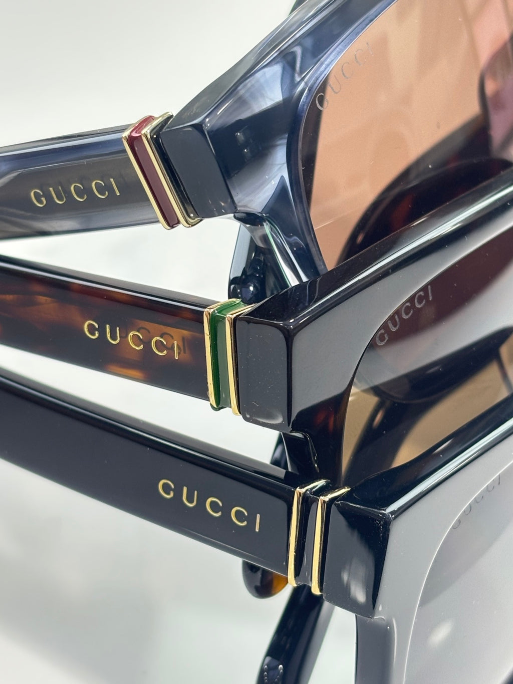 Gucci sunglasses hinge detail with gold-tone accents on dark acetate frame