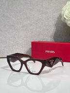 Black rectangular eyeglasses with tortoiseshell temple tips and clear lenses, Prada