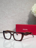 Square tortoise acetate eyeglasses with dark lenses and Prada logo on front
