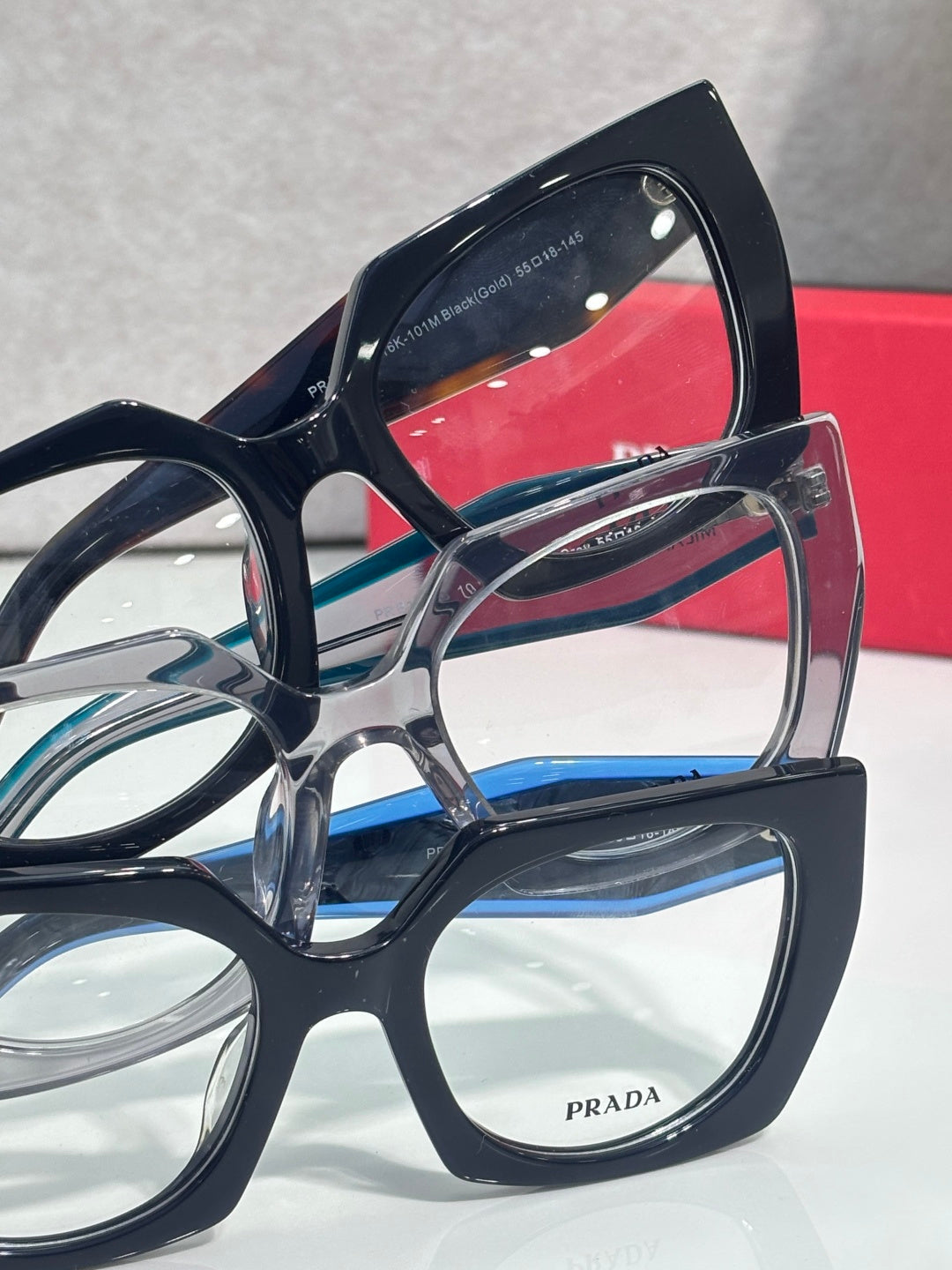 Blue and black square eyeglasses with Prada logo on temple