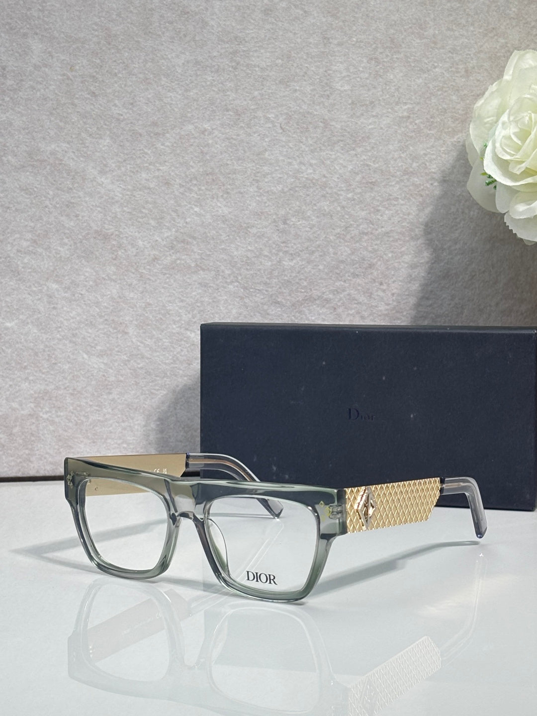 Dior eyeglasses with clear-olive square frames and gold textured temple detail