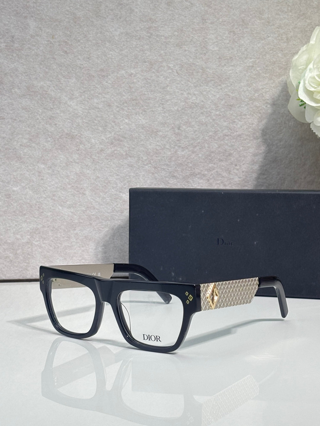 Dior eyeglasses with black square frames and gold textured temple detail