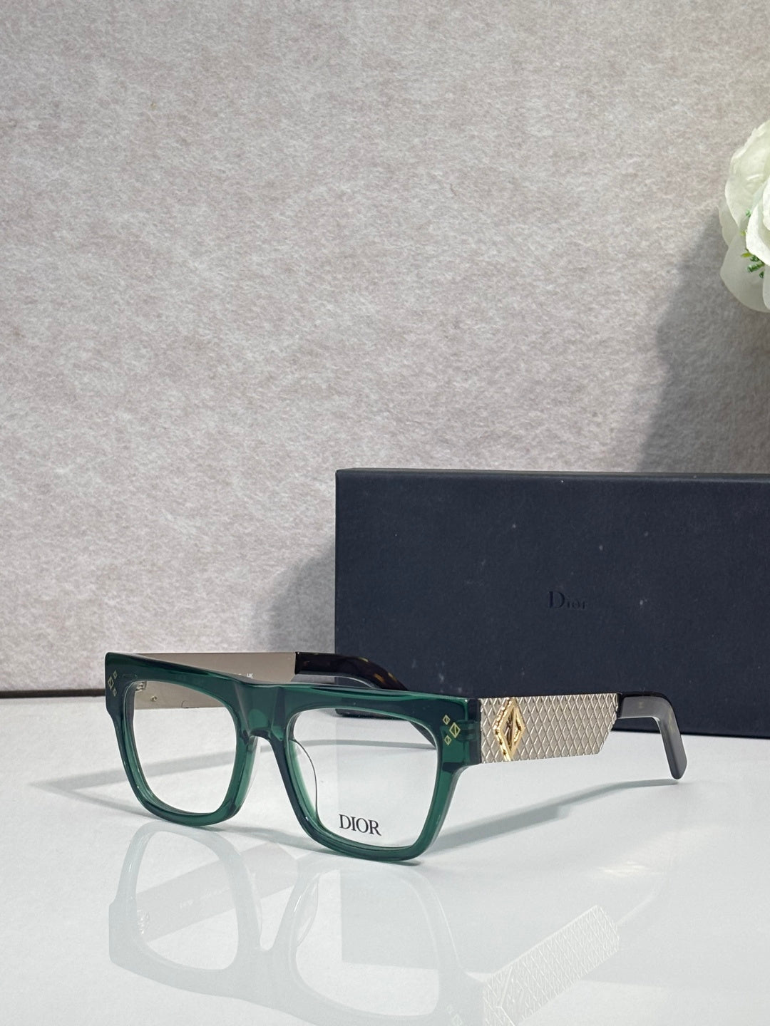 Dior eyeglasses with green square frames and gold textured temple detail
