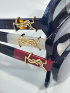 Navy eyeglass frame with gold logo bar temple detail